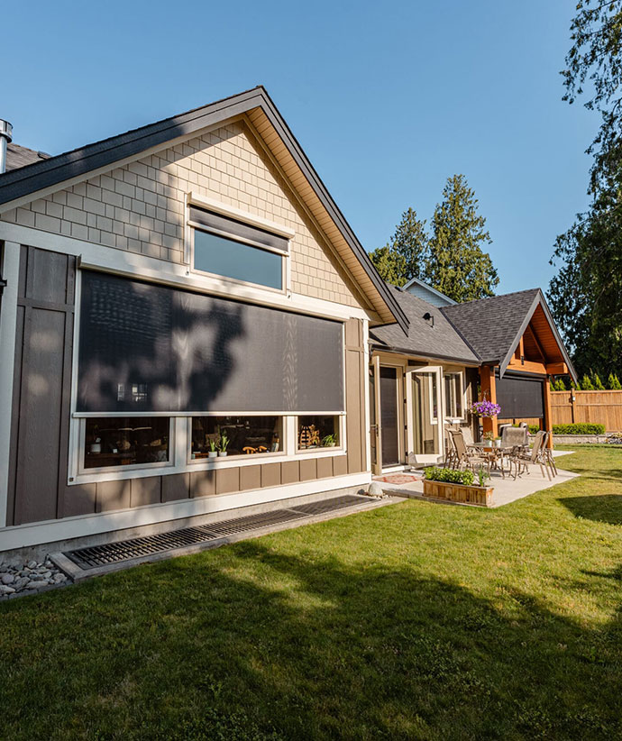 Modern home exterior featuring mounted motorized screen system